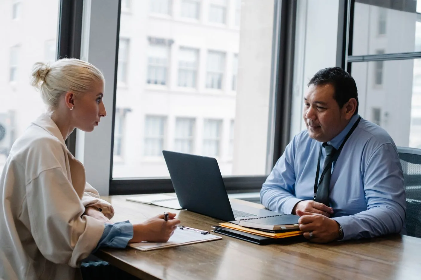 An employer interviewing an international candidate in a modern office
